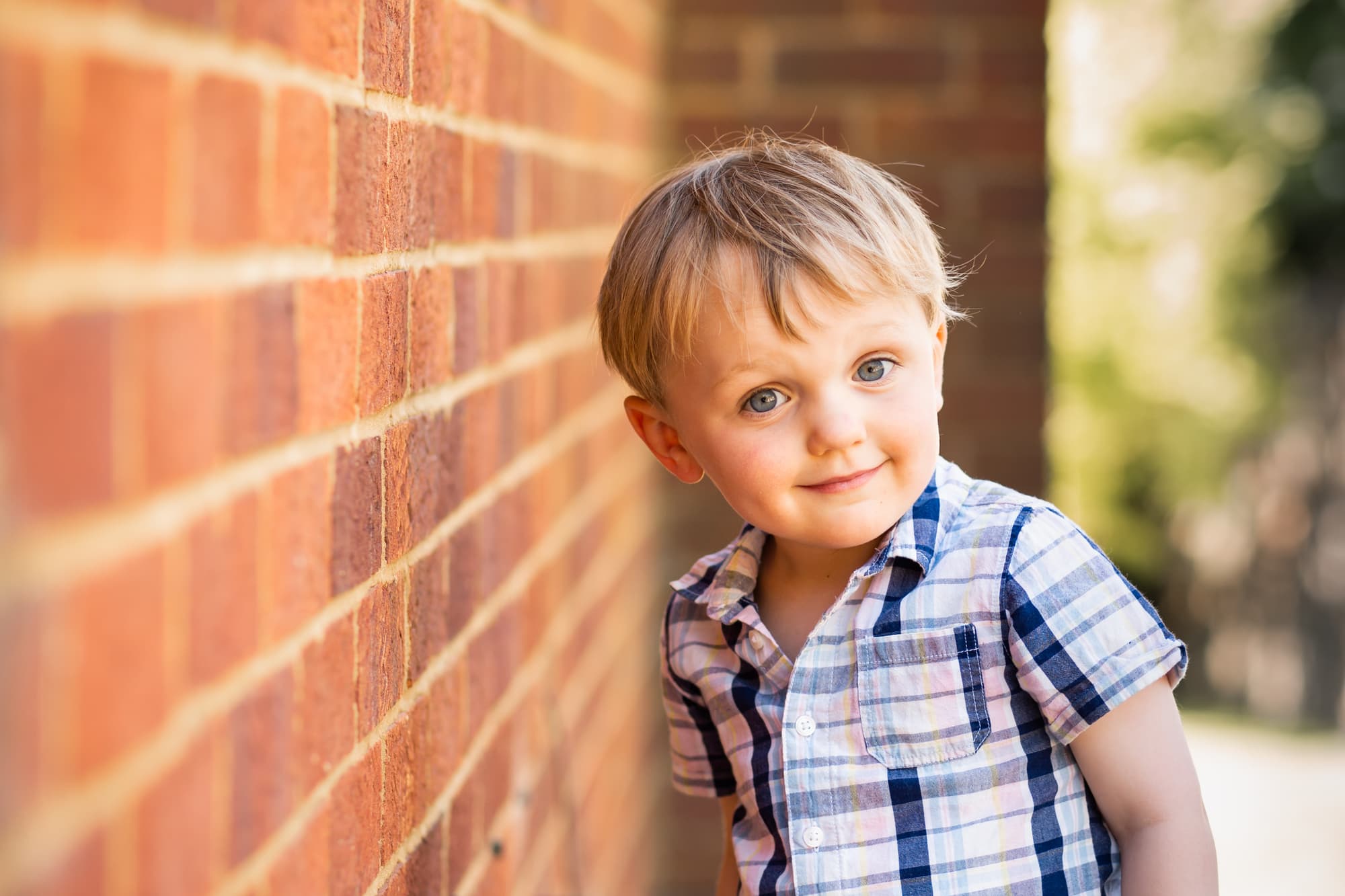 little blonde boy in shirt smiling at the camera